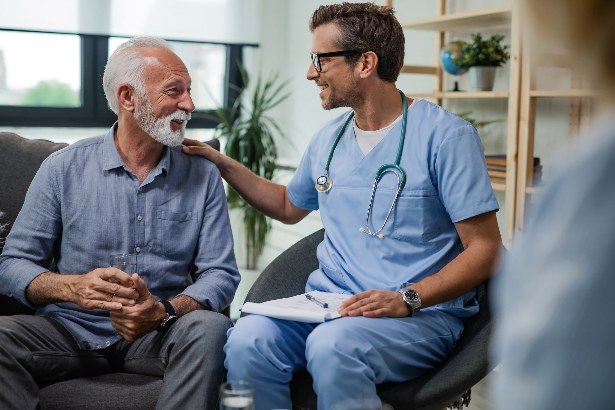 clinician-reassuring-senior-patient-in-clinic